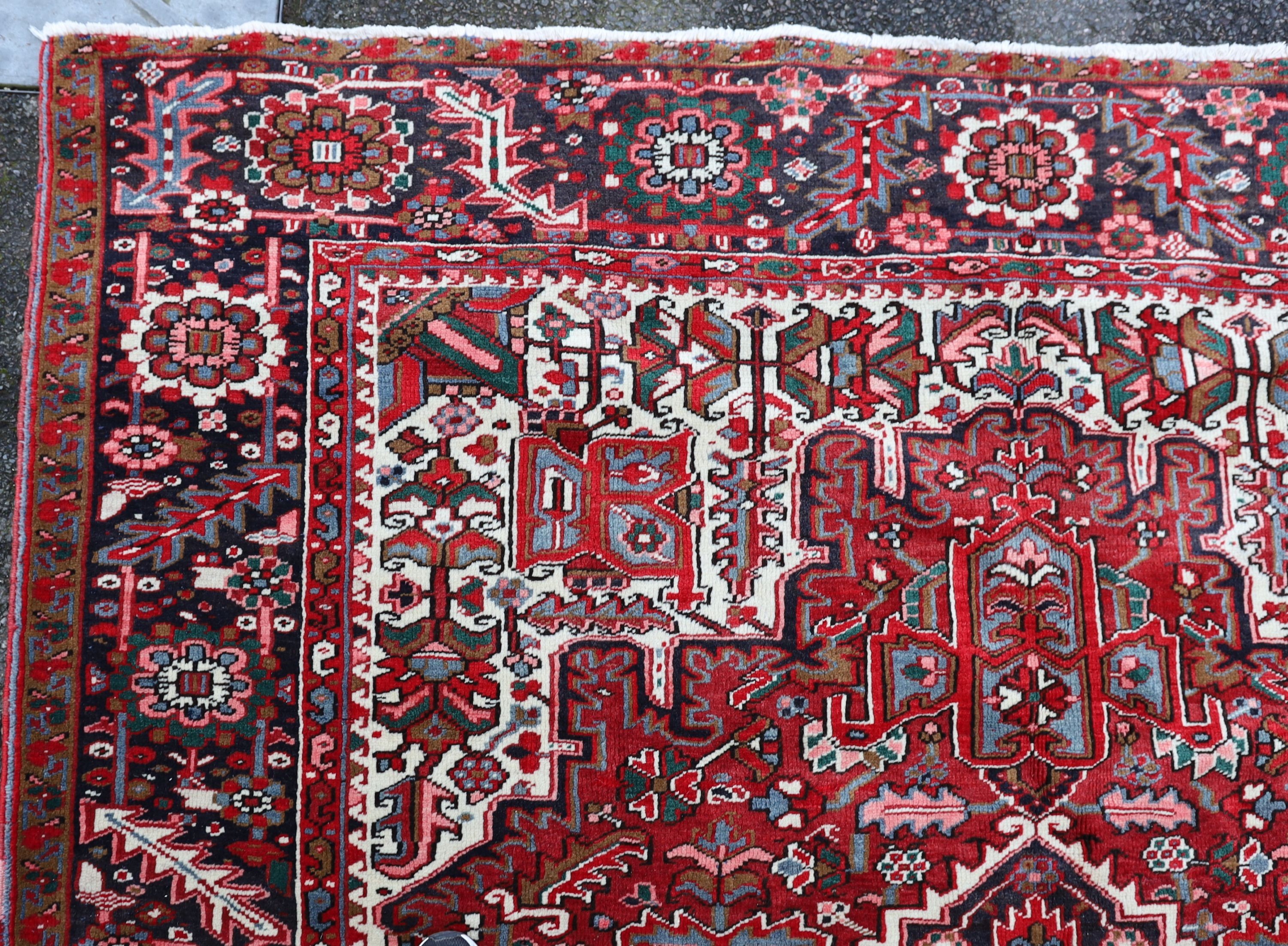 A Heriz red ground carpet, 324 x 243cm.
